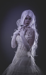 Sensual lady in white corset, long hair, handmade dress