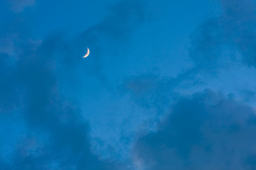 Obraz na płótnie Canvas Moon on blue sky with clouds