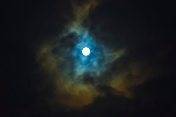 Obraz na płótnie Canvas Full moon on dramatic cloudy sky