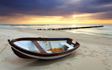 Boat on beautiful beach in sunrise