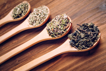 Various spices in wooden spoons