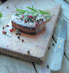 Beef steak with fresh rosemary and color pepper
