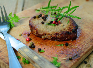 Grilled beef steak with fresh rosemary and pepper