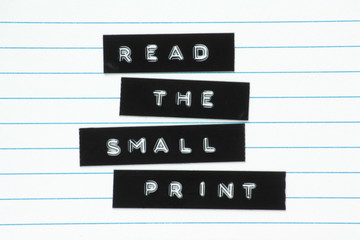 Read The Small Print printed labels on lined paper