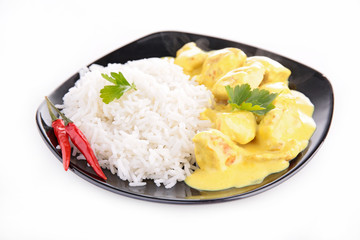 plate of rice and curry chicken