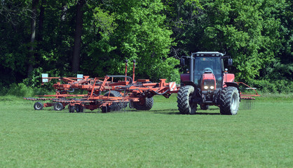 lawn tractor mows the lawn in the park