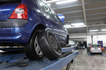 car in garage with special equipment prepared for repair