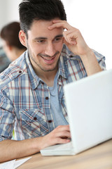 Young man working in office on computer