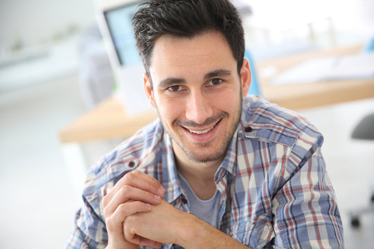 Smiling young adult in office