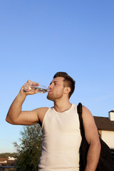 Thirsty athlete drinking water after workout