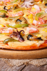 pizza with shrimp, mussels and octopus closeup on table