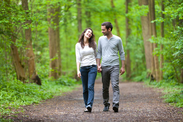 Young couple having a walk in a forest