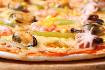 Pizza ai frutti di mare with octopus, mussels and shrimp macro