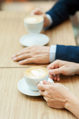 Drinking coffee together.