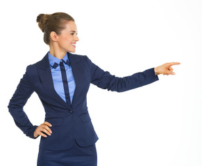 Happy business woman pointing on copy space