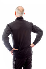 Rear view of a senior man standing with his arms akimbo
