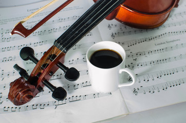 Closeup photo of violin and cup of coffee © rueangwit