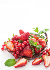 Fresh strawberry and redcurrant on white