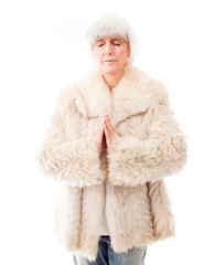 Senior woman standing in prayer position