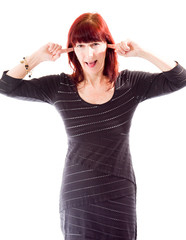 Mature woman standing with fingers in her ears