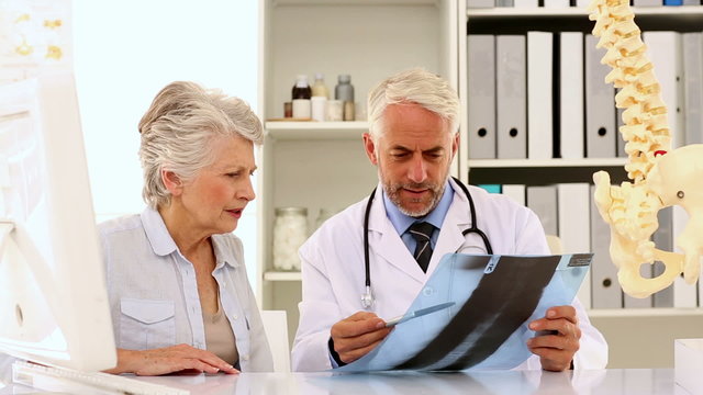 Doctor explaining a spine xray to patient