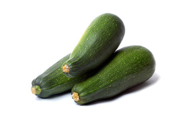 Three fresh vegetable zucchini isolated on white