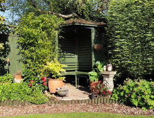 An English back Garden with Bench and Flower basket