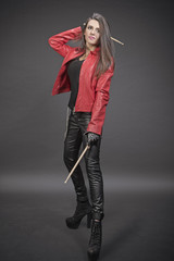 Portrait of young brunette musician woman with drumsticks