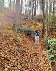 Taking photo in autumn forest