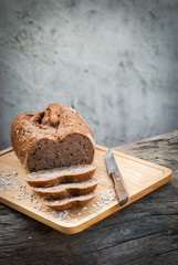 Several slices of Bread wheat and wooden chopping board