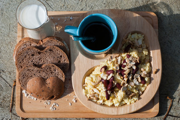 Breakfast with scrambled eggs, toasts, milk and coffee
