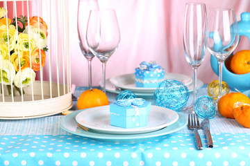 Table serving with colorful tableware on room background