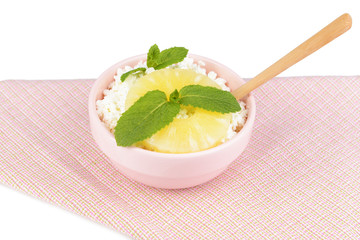 Bowl of tasty cottage cheese with pineapple, isolated on white