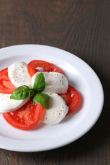 Caprese salad with mozarella cheese, tomatoes and basil