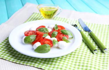 Caprese salad with mozarella cheese, tomatoes and basil