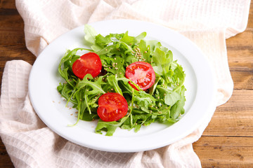 Green salad made with  arugula, tomatoes and sesame
