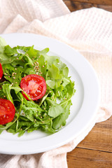 Green salad made with  arugula, tomatoes and sesame
