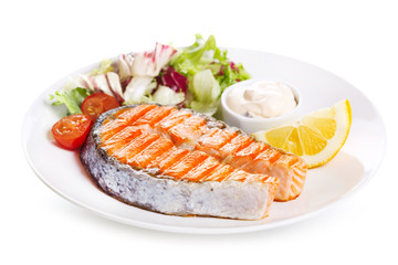 plate of grilled salmon steak with vegetables