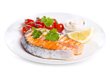 plate of grilled salmon steak with vegetables