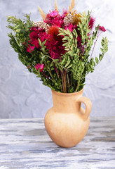 Beautiful bouquet of bright flowers in pitcher