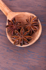 Spoon with beautiful anise, on wooden table
