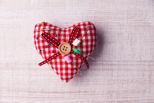 Fabric heart with color pins and safety pins