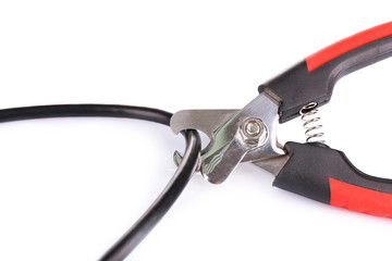 Side cutters cut cable isolated on white