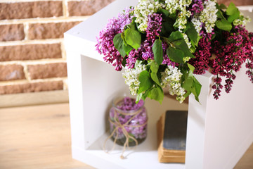Beautiful lilac flowers in wicker basket,