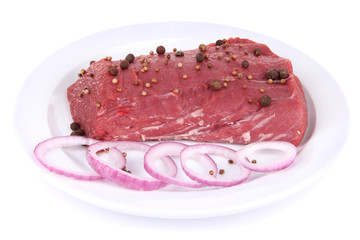 Raw beef meat with spices on plate isolated on white