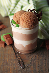 Tasty chocolate mousse with sorbet on wooden table