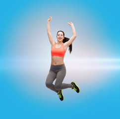 sporty teenage girl jumping in sportswear