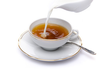 Milk poured into a cup of tea