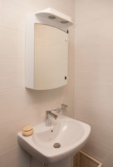 Vertical Shot of light bathtub in a bathroom.