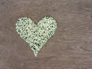 Shelled hemp seeds shaped in a heart symbol
